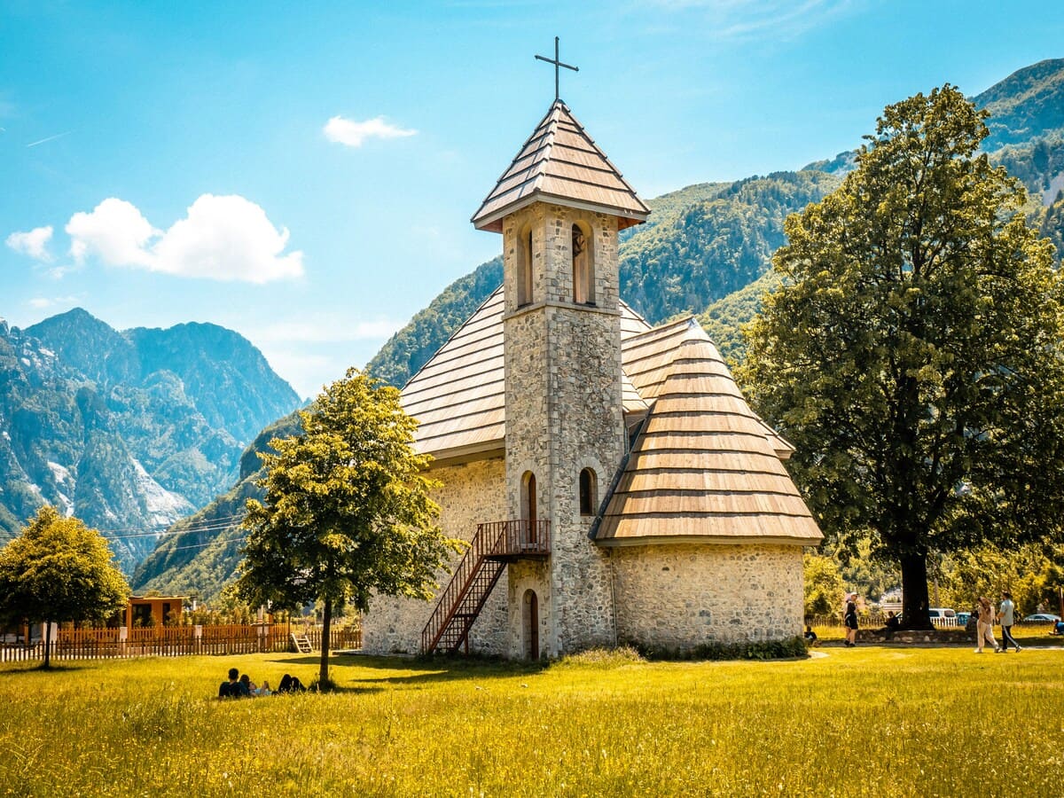Theth Church beneath the peaks of the Albanian Alps in northern Albania