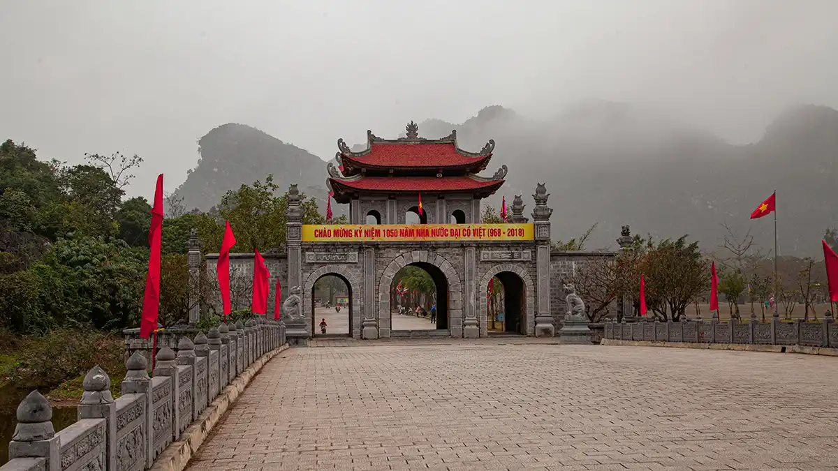Stone gate at Hoa Lu Ancient Capital with limestone mountains in the background