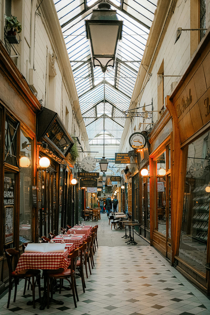 Historic covered passage in Paris with tiled floor and boutique shops