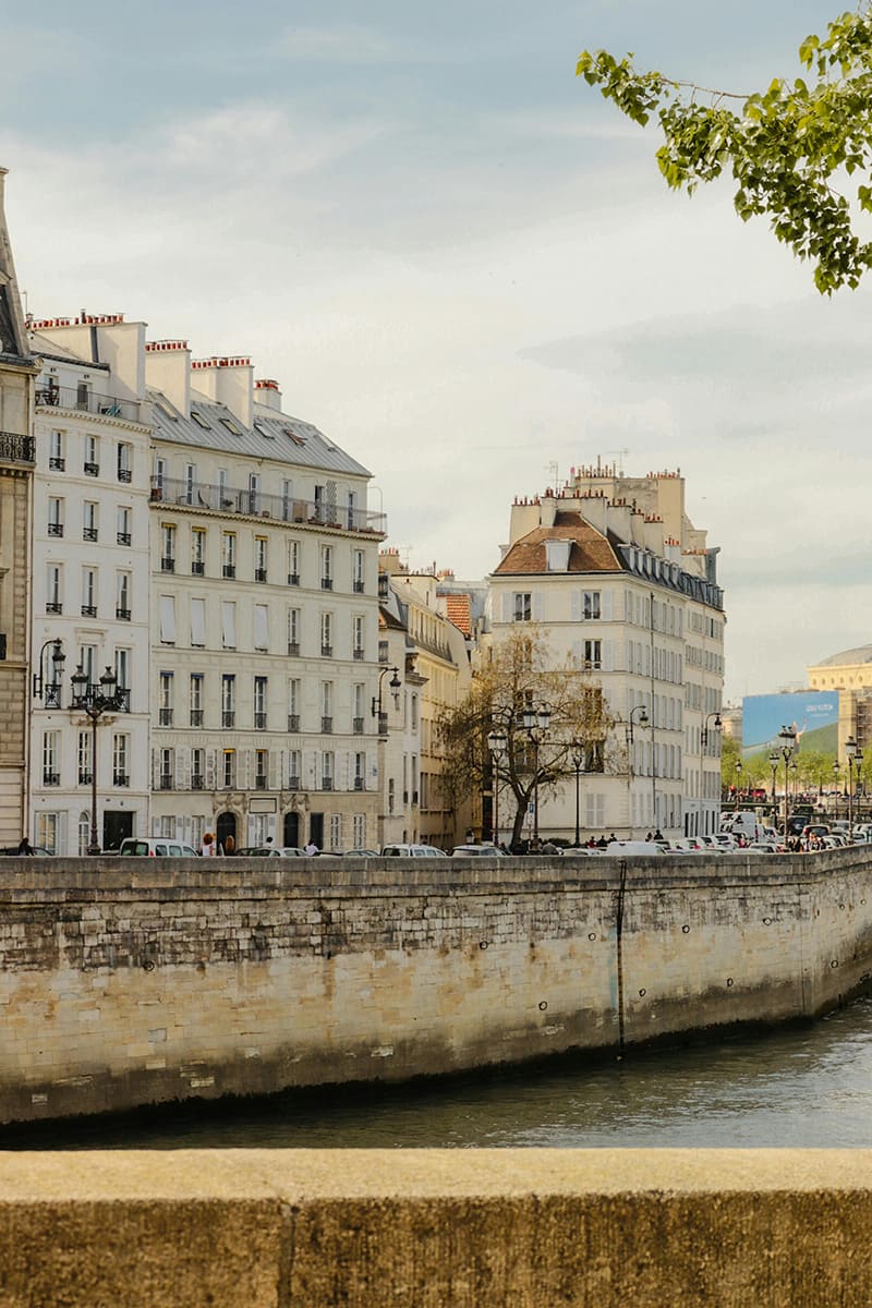Quiet street and river wall view on Île Saint-Louis showing classic Paris architecture