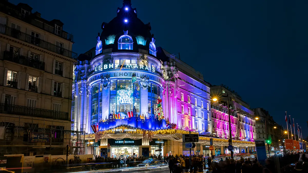 Illuminated BHV Marais building on Rue de Rivoli at night