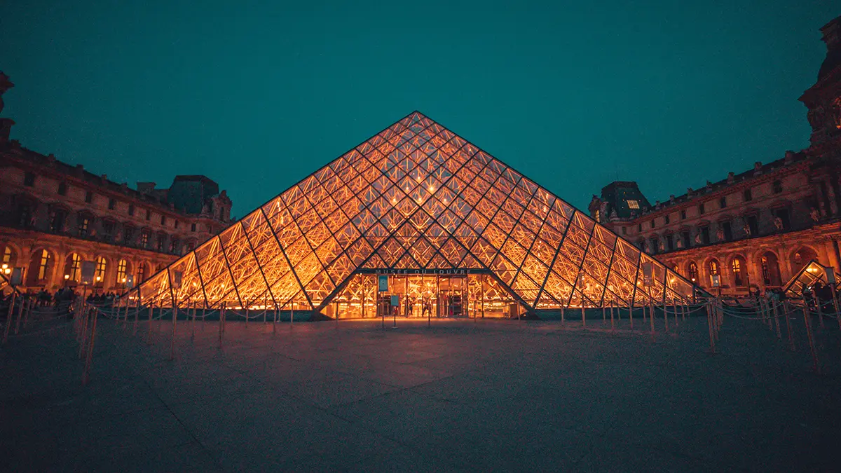 Louvre Pyramid illuminated in the museum courtyard at night