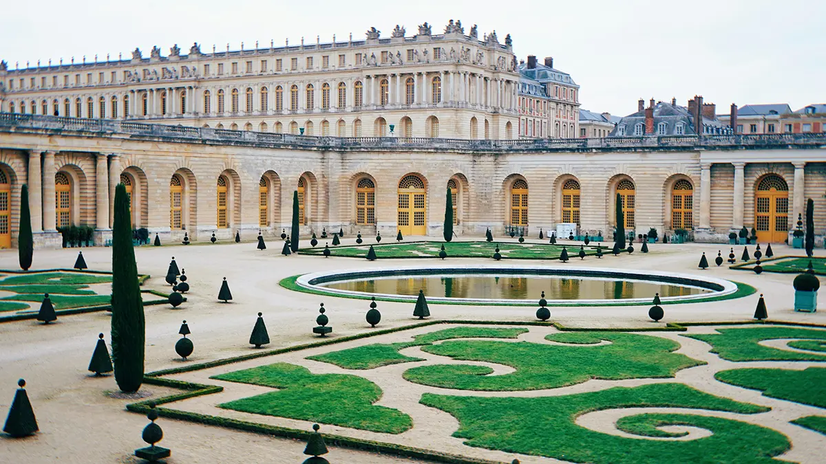 Palace of Versailles facade behind formal parterre gardens