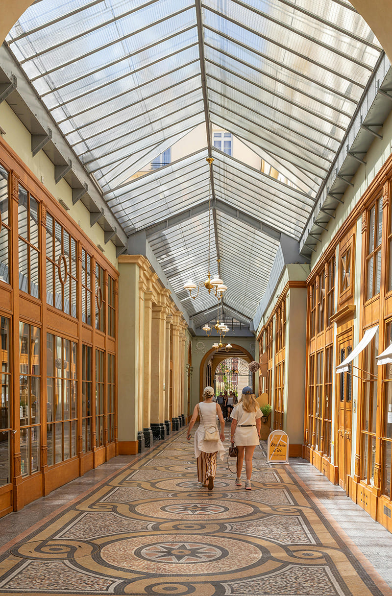 Passage Jouffroy in Paris with cafes and small shops inside a covered walkway