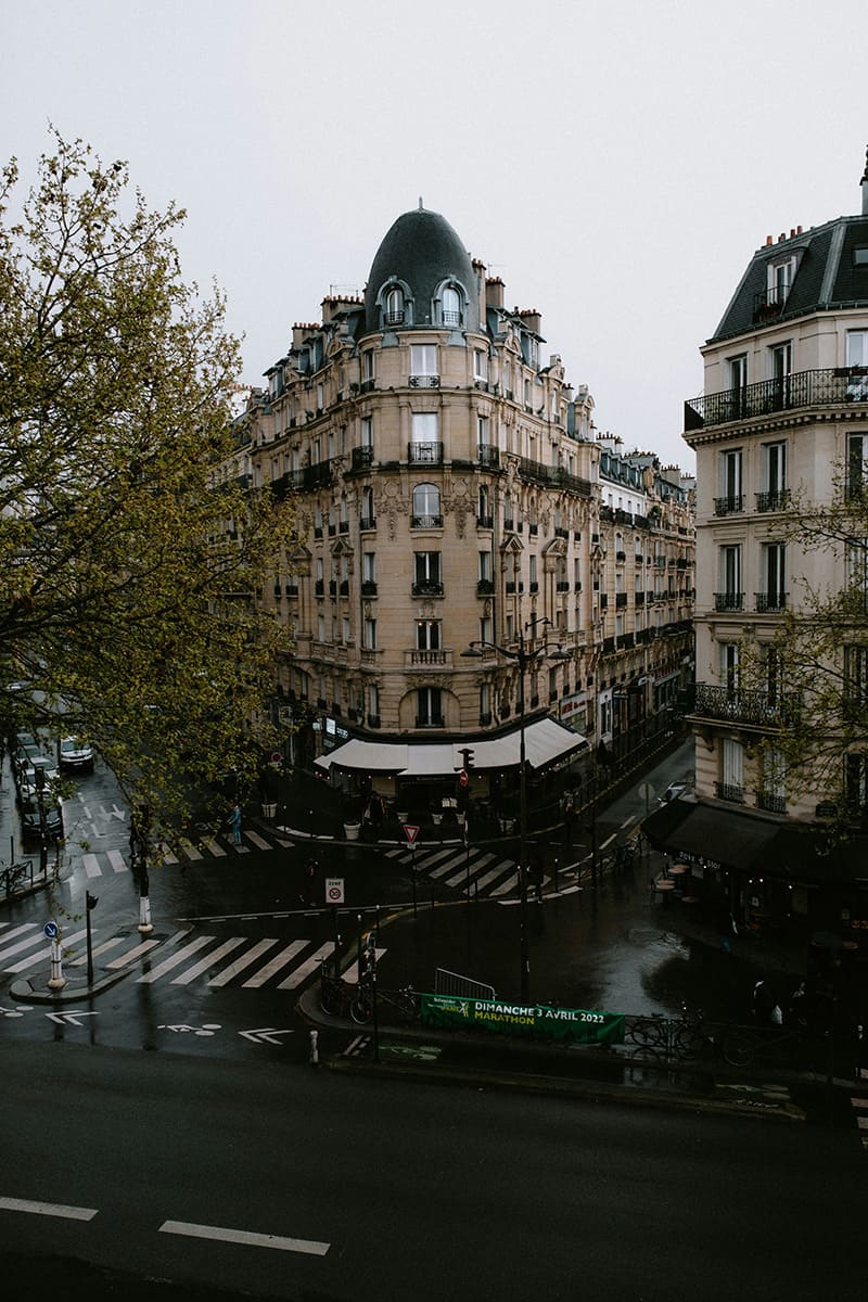 View from Promenade Plantée overlooking a Paris street intersection on a rainy day