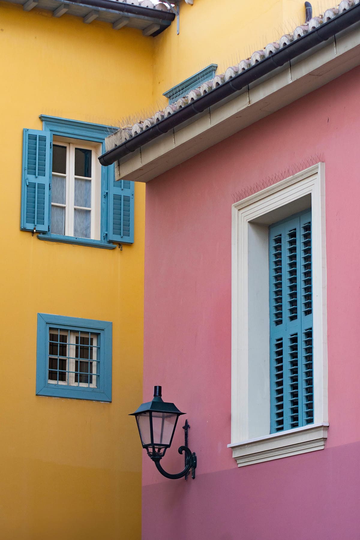 Colorful pastel houses on Rue Crémieux in Paris with blue shutters and bright walls