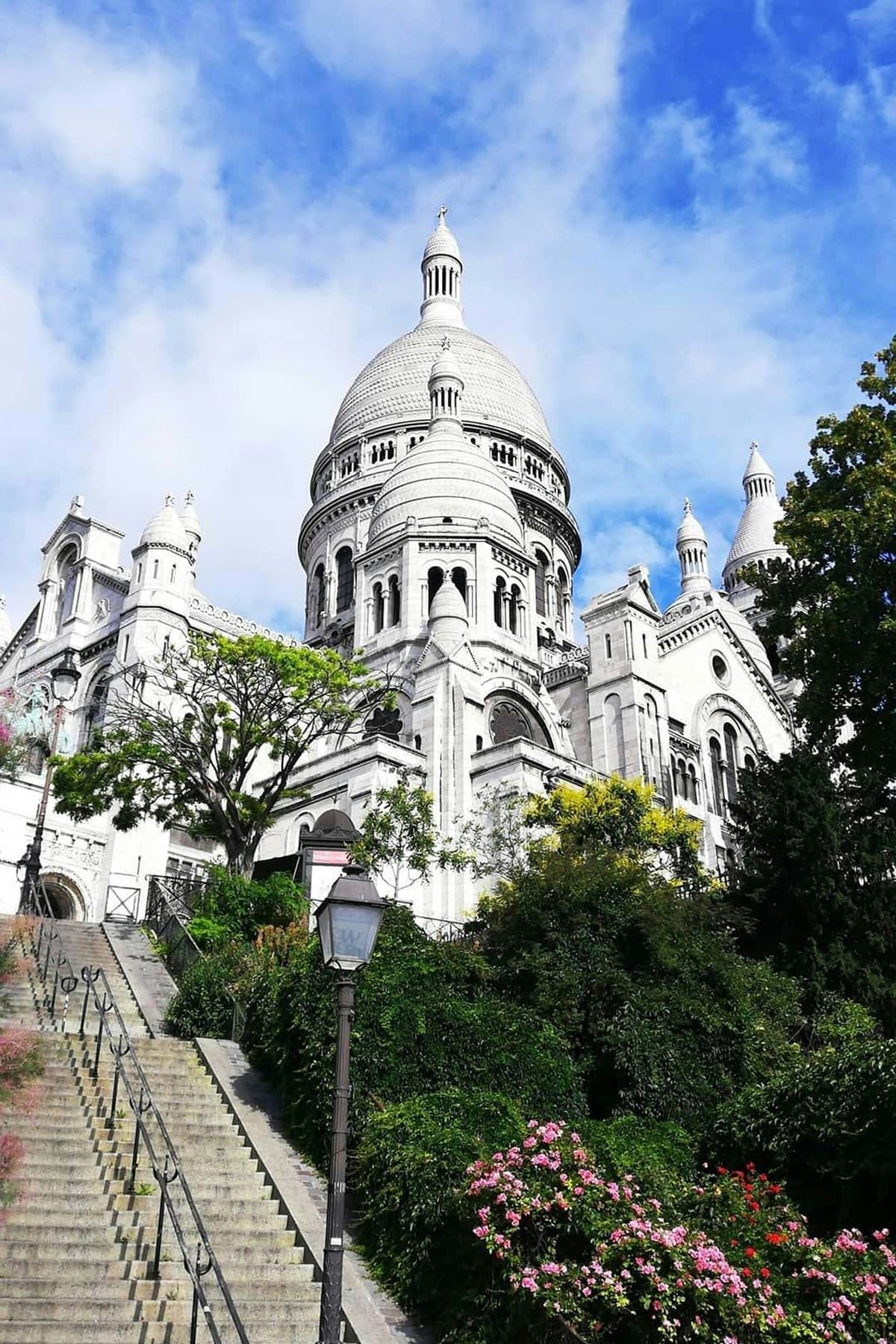Sacré Coeur Basilica in Montmartre with stairs and garden view in Paris