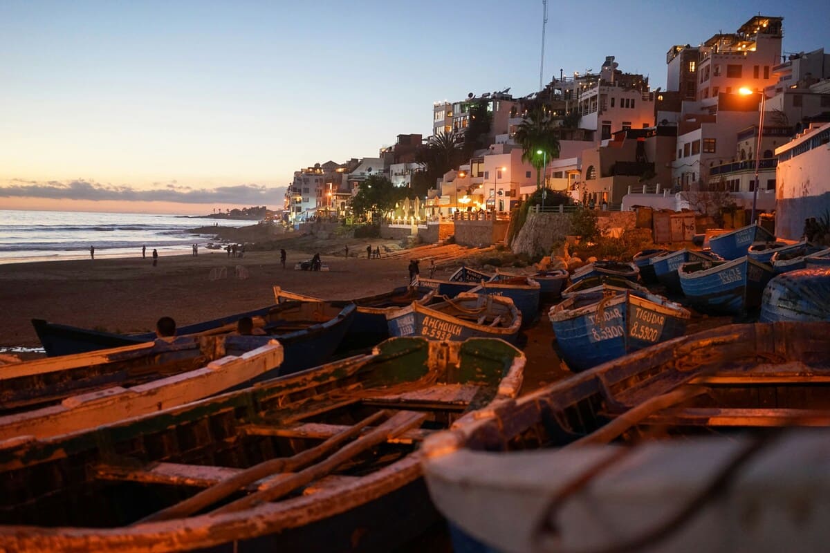 Fishing boats on the beach at sunset in Essaouira Morocco