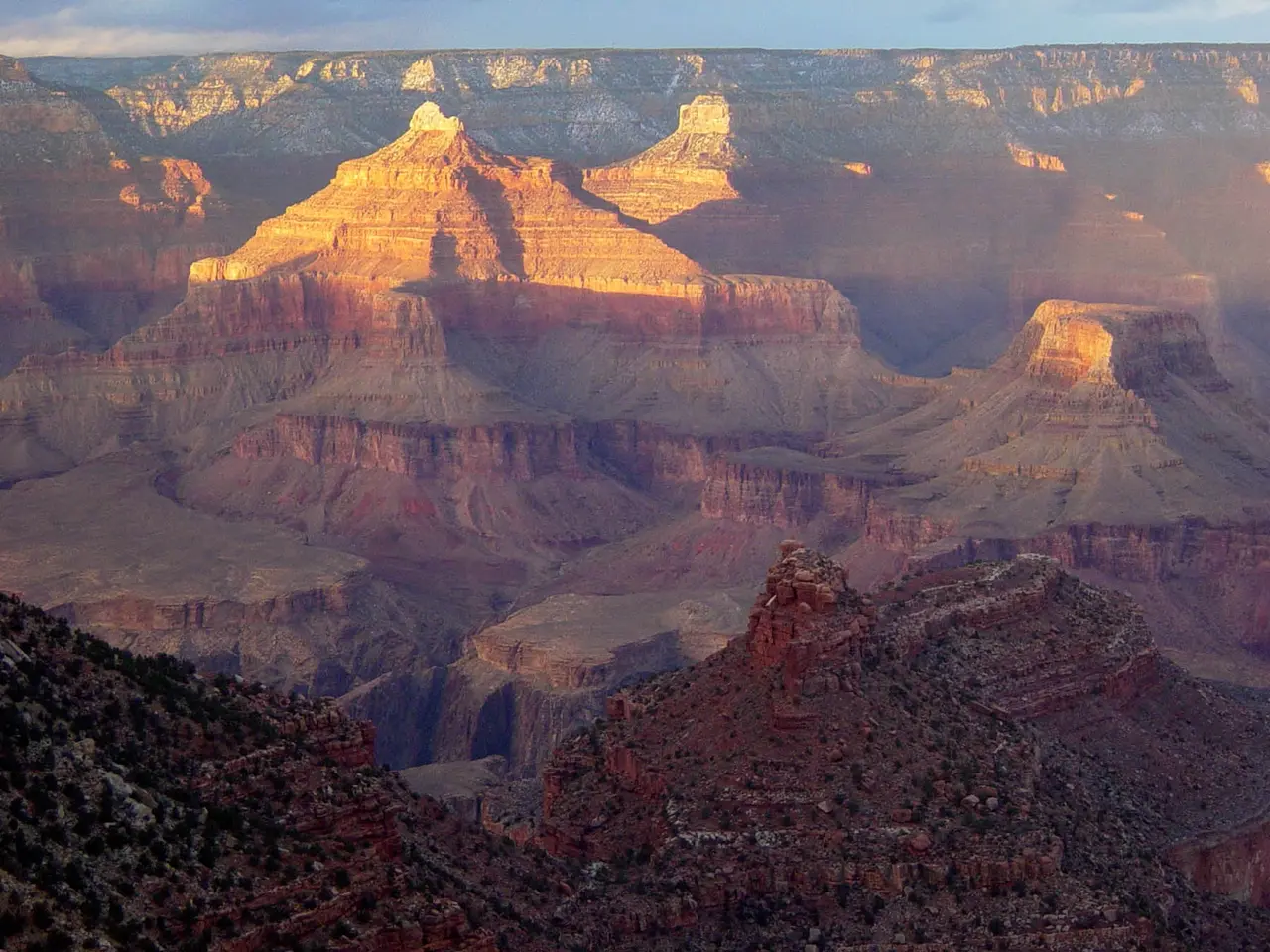 Low evening light illuminating formations above Grand Canyon Village