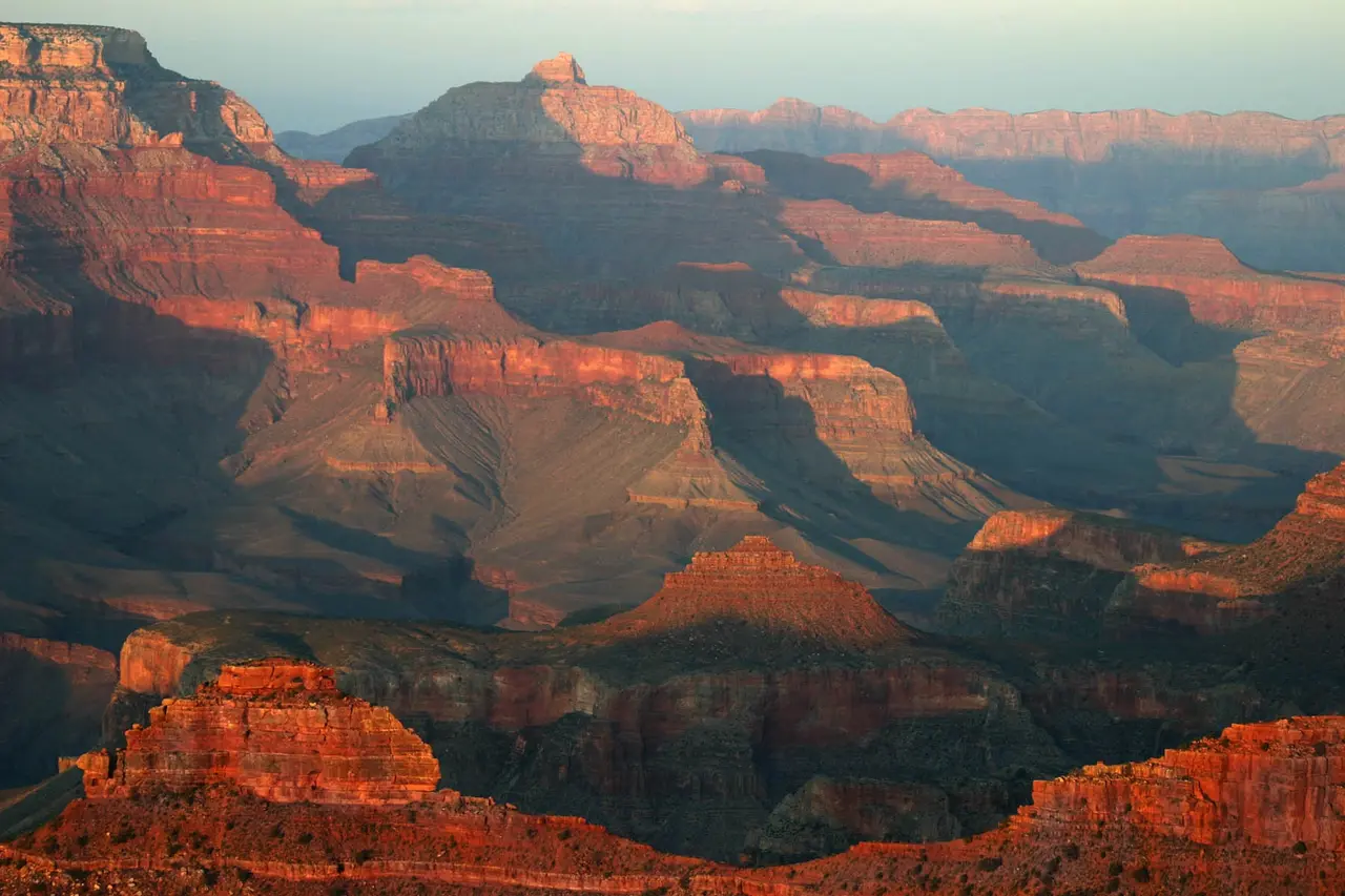 Layered Grand Canyon formations lit by low sun from Yavapai Point