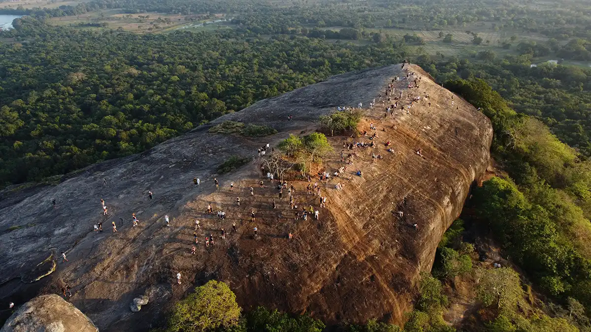 Hikers on the rocky summit of Pidurangala near Sigiriya