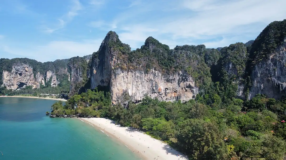 Longtail boats and limestone cliffs near Railay Beach in Krabi
