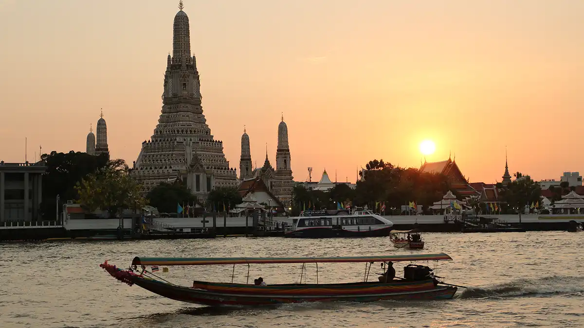 Bangkok river and temple skyline on a first-time Thailand itinerary