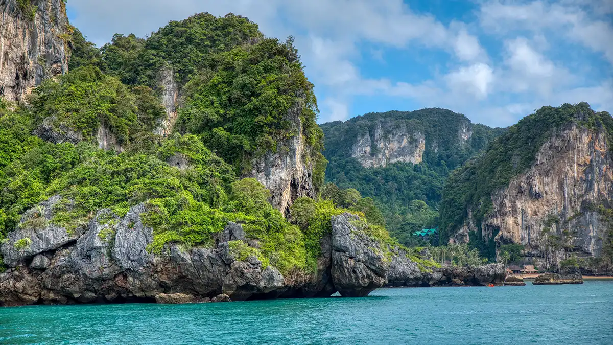 Longtail boats and limestone cliffs near Krabi in southern Thailand