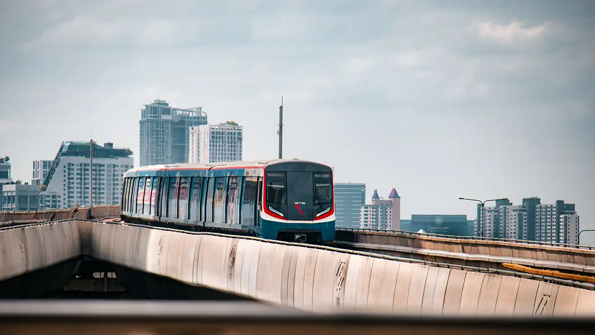 BTS Skytrain travelling above Bangkok during a public transport itinerary