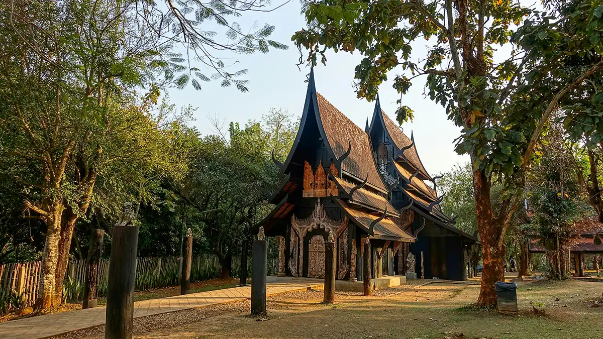 Dark wooden temple in Chiang Rai on a northern Thailand culture route