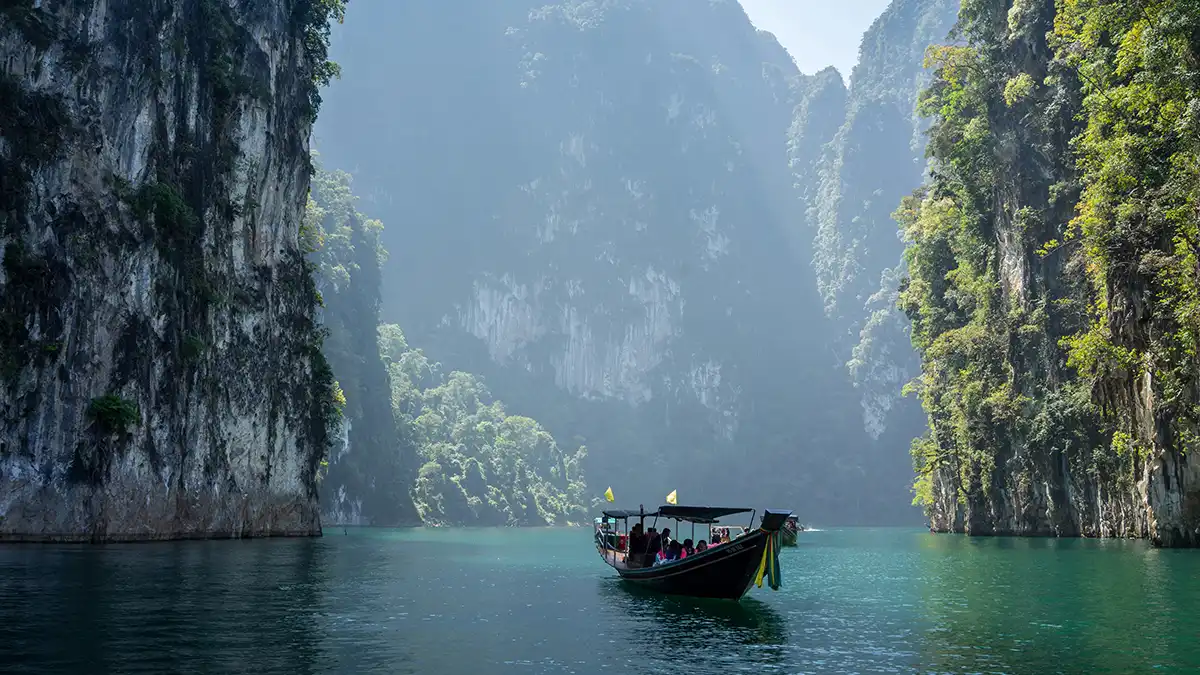 Longtail boat between limestone cliffs in Khao Sok National Park Thailand