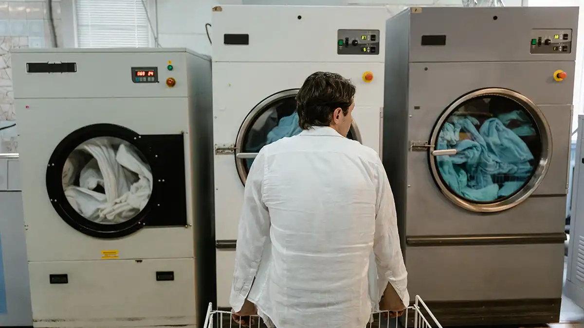 Traveler using a self-service laundry during a Thailand backpacking trip