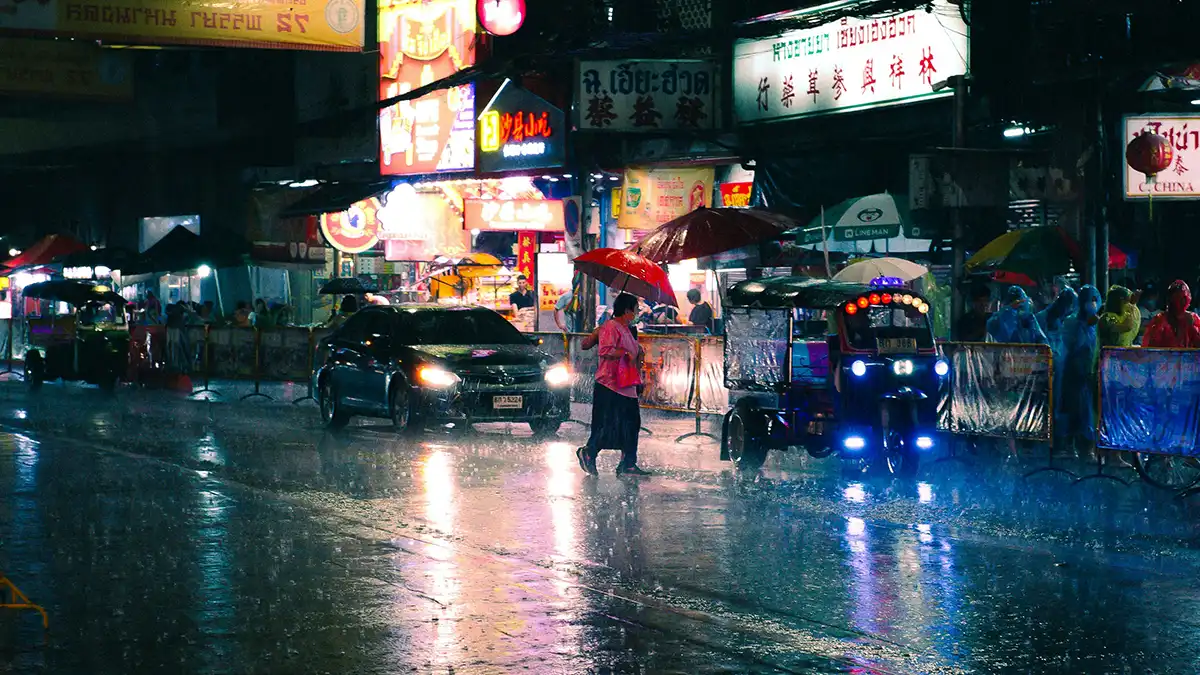 Traffic and tuk-tuks during heavy rain in Bangkok Thailand