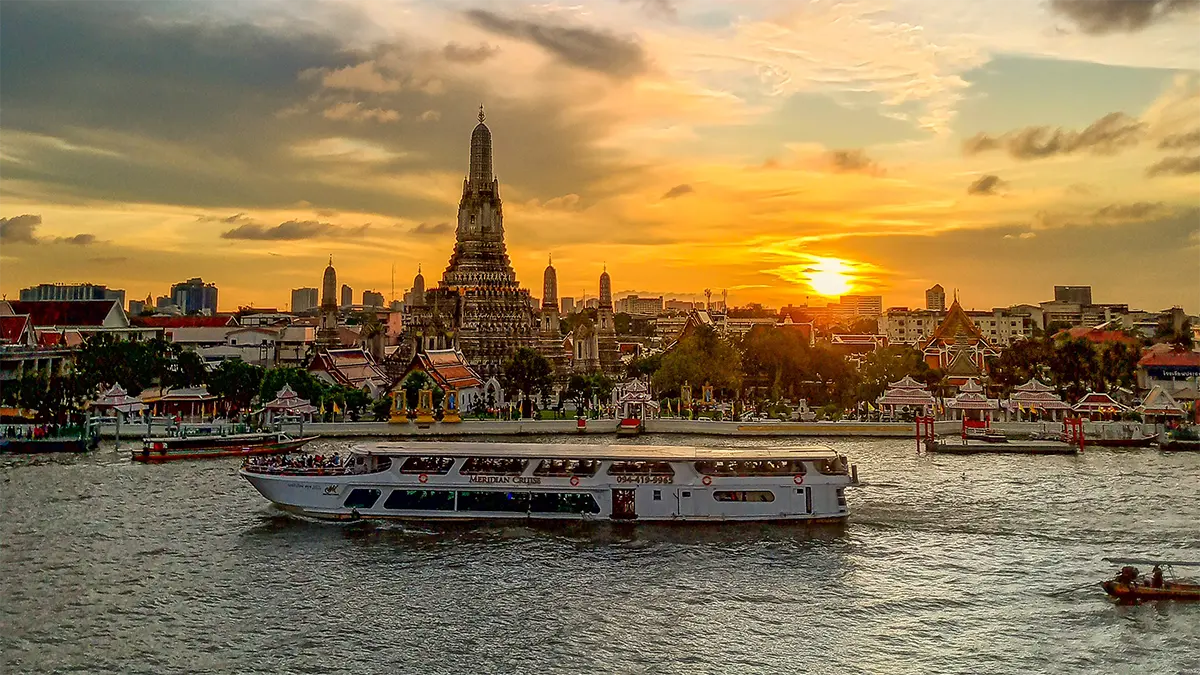 Wat Arun and a river boat on the Chao Phraya River in Bangkok