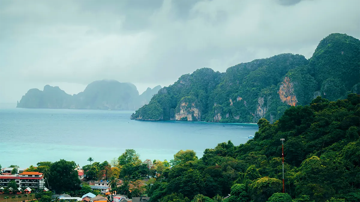 Visitors and boats at a beach in the Phi Phi Islands