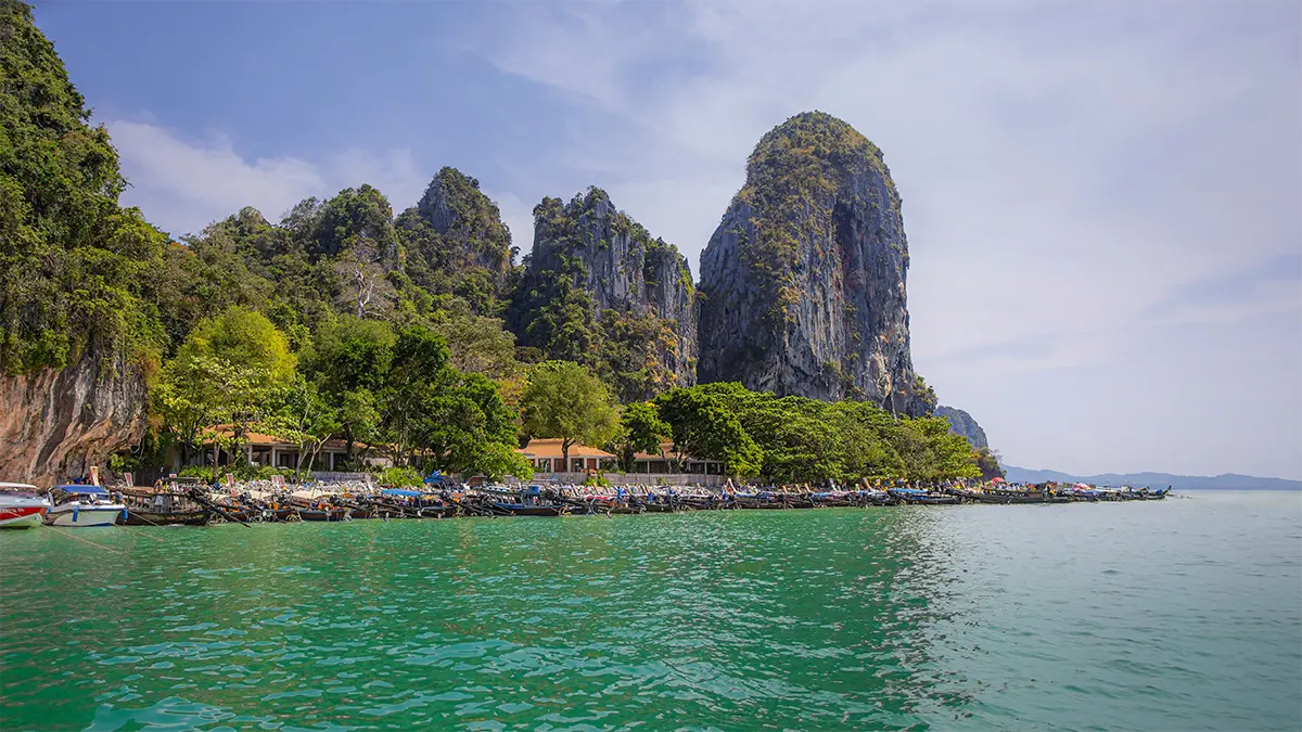 Longtail boats and limestone cliffs near Railay in Krabi