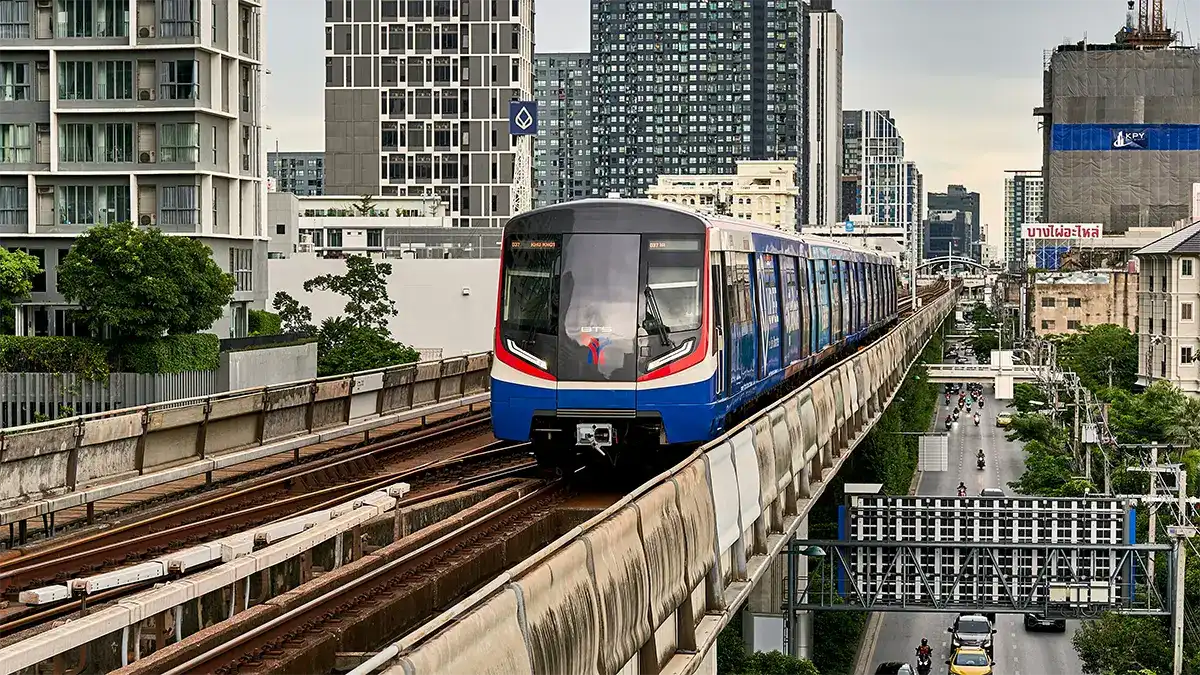 Elevated BTS train arriving at a station in Bangkok
