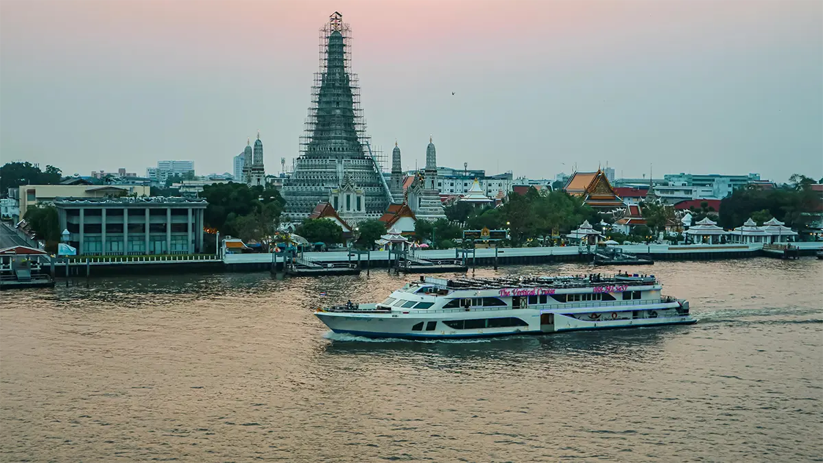 River ferry passing Wat Arun on the Chao Phraya River in Bangkok