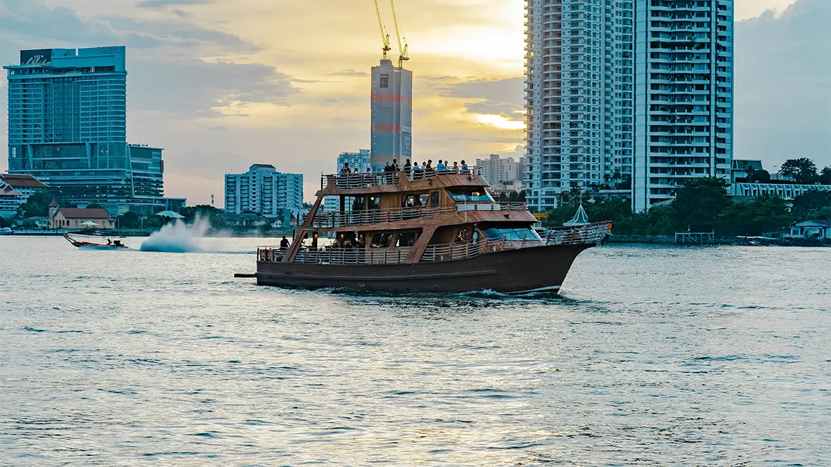 Passenger boat traveling along the Chao Phraya River in Bangkok