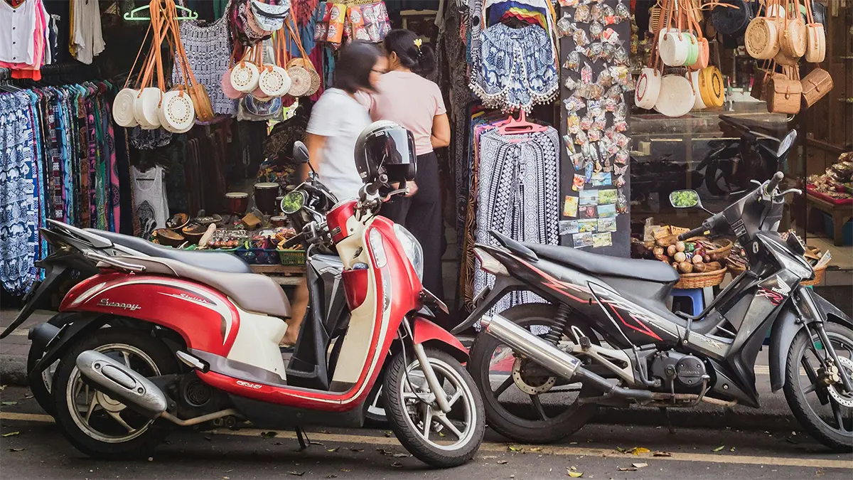Scooters parked beside a road in Thailand