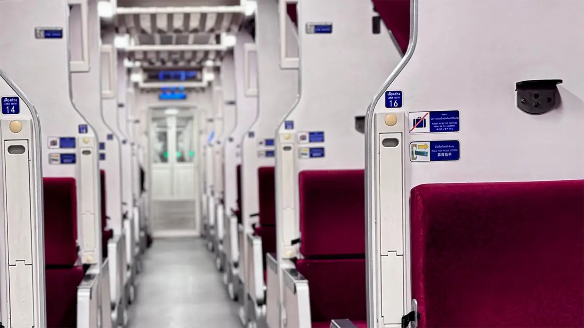 Prepared sleeper berth inside a long-distance train in Thailand