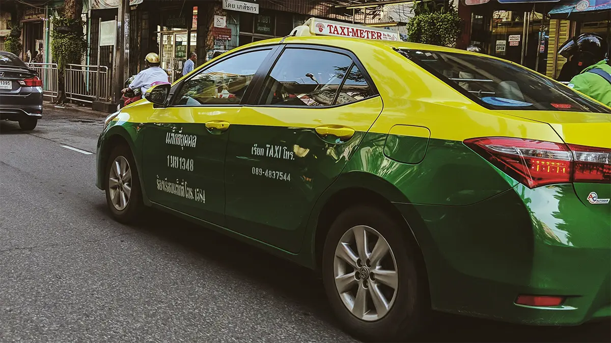 Passenger meeting a taxi or app-based ride in Thailand