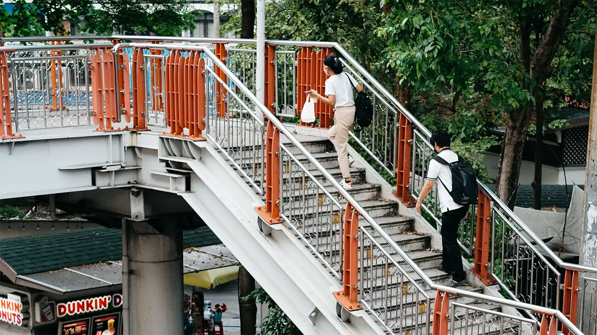 Traveler moving a large suitcase through a transport terminal in Thailand